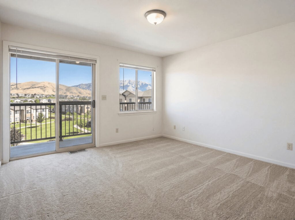 Empty living room with large windows and mountain view, ready for renovation or move-in. Perfect space for home customization.
