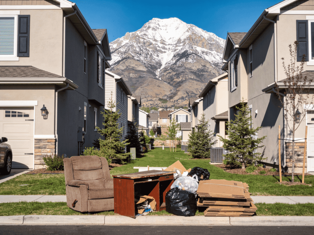 Trash and furniture left outside homes for junk removal service.